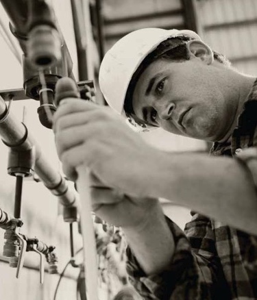 Plumber working on pipes
