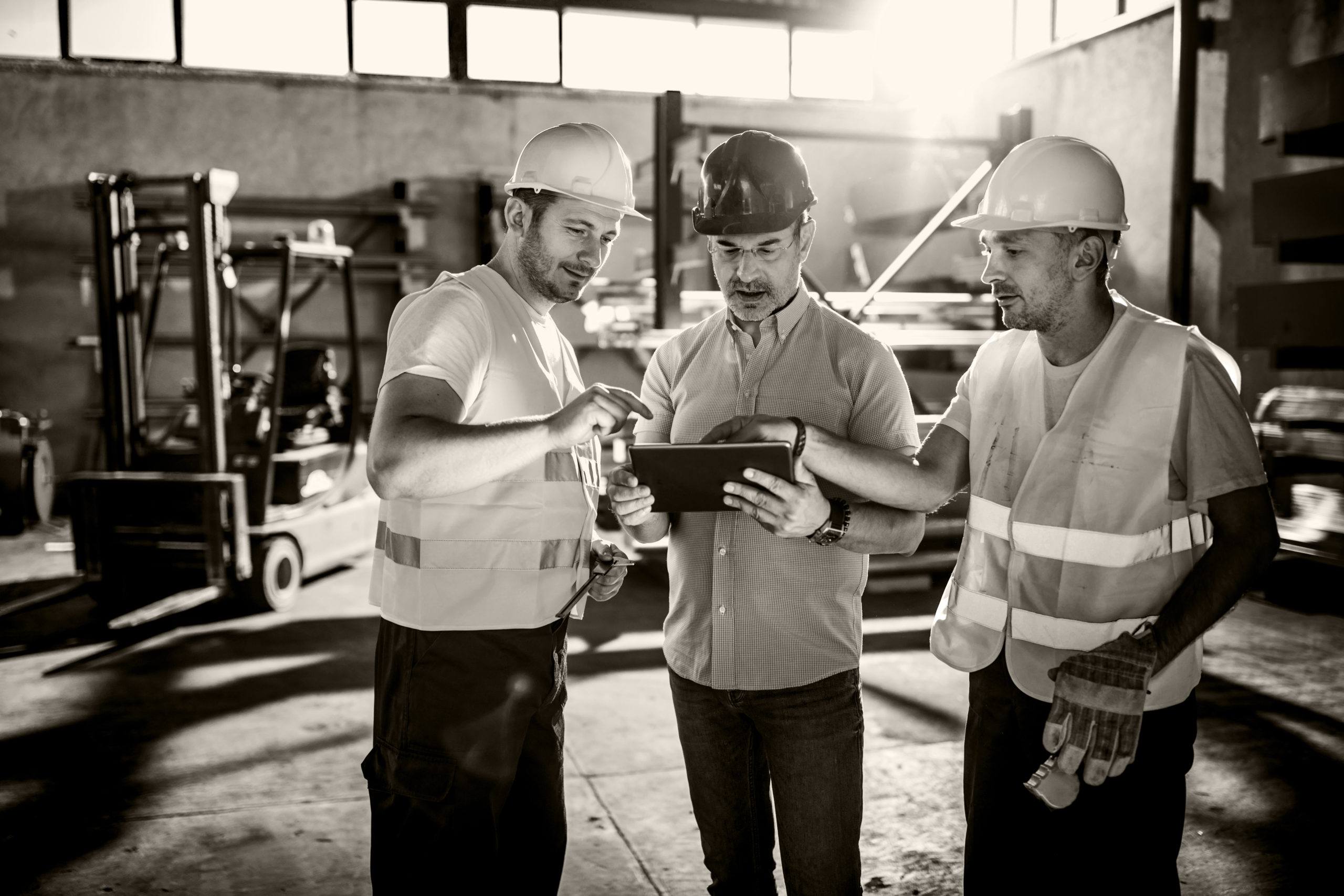 image of 3 men talking with construction gear on