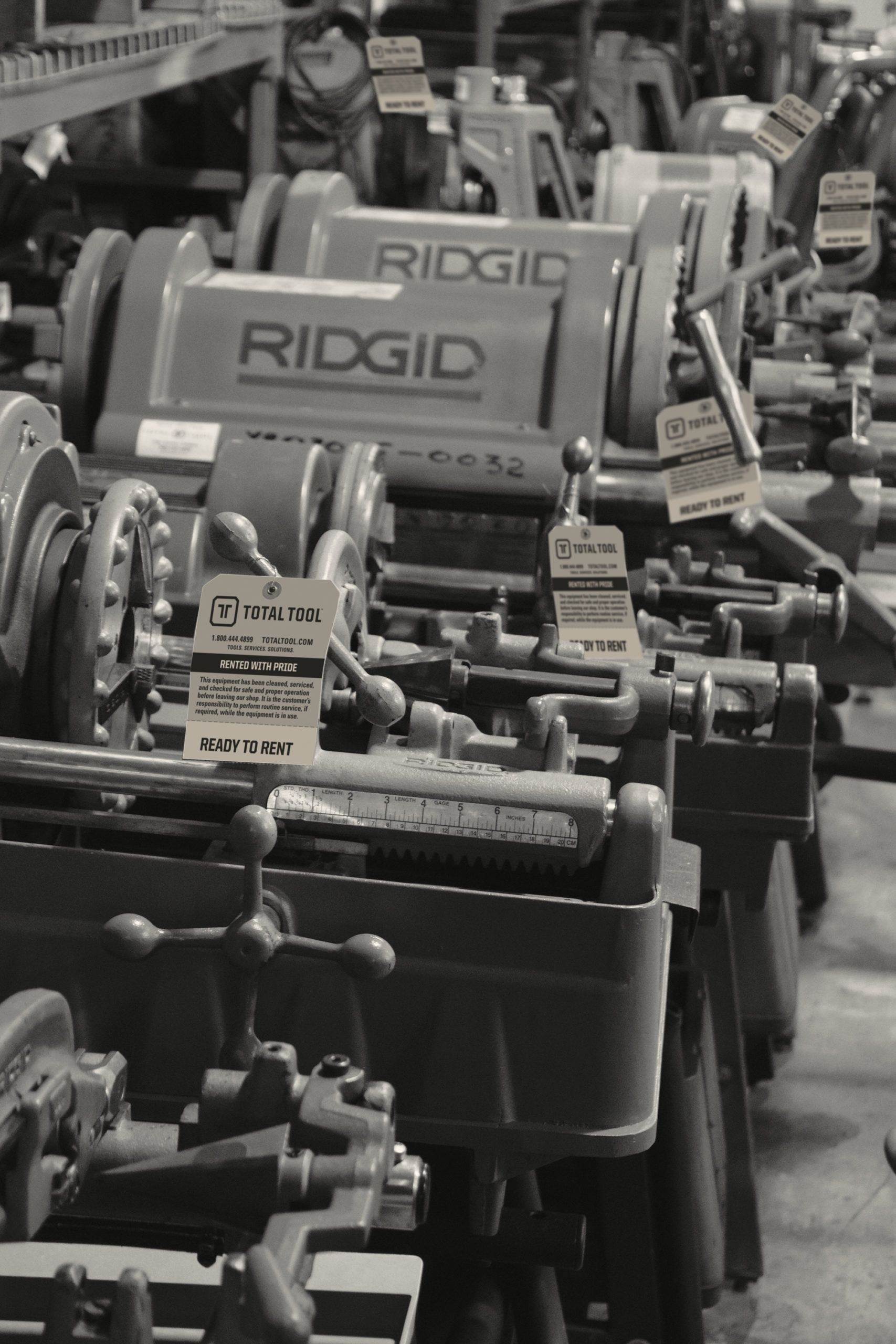 row of industrial tools with total tool rental tracking tags attached